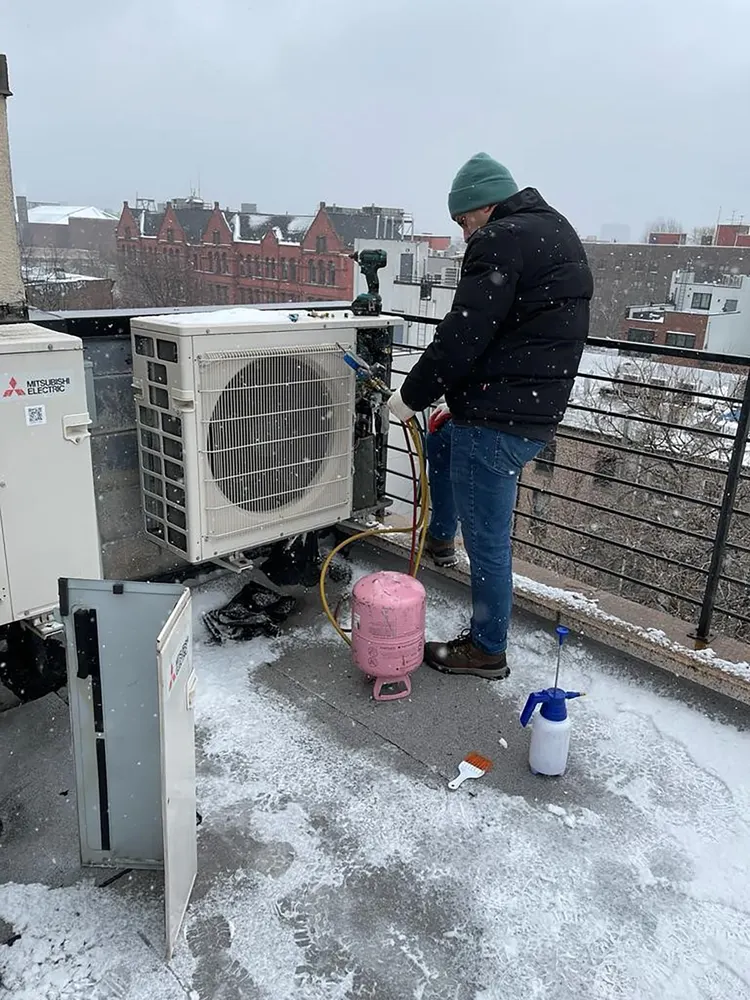 Chill Factor technician working on a rooftop condenser install